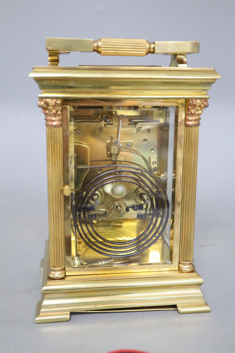 An early 20th century French lacquered brass oversized carriage clock, striking on a gong, movement by Japy Freres four glass mantel cl